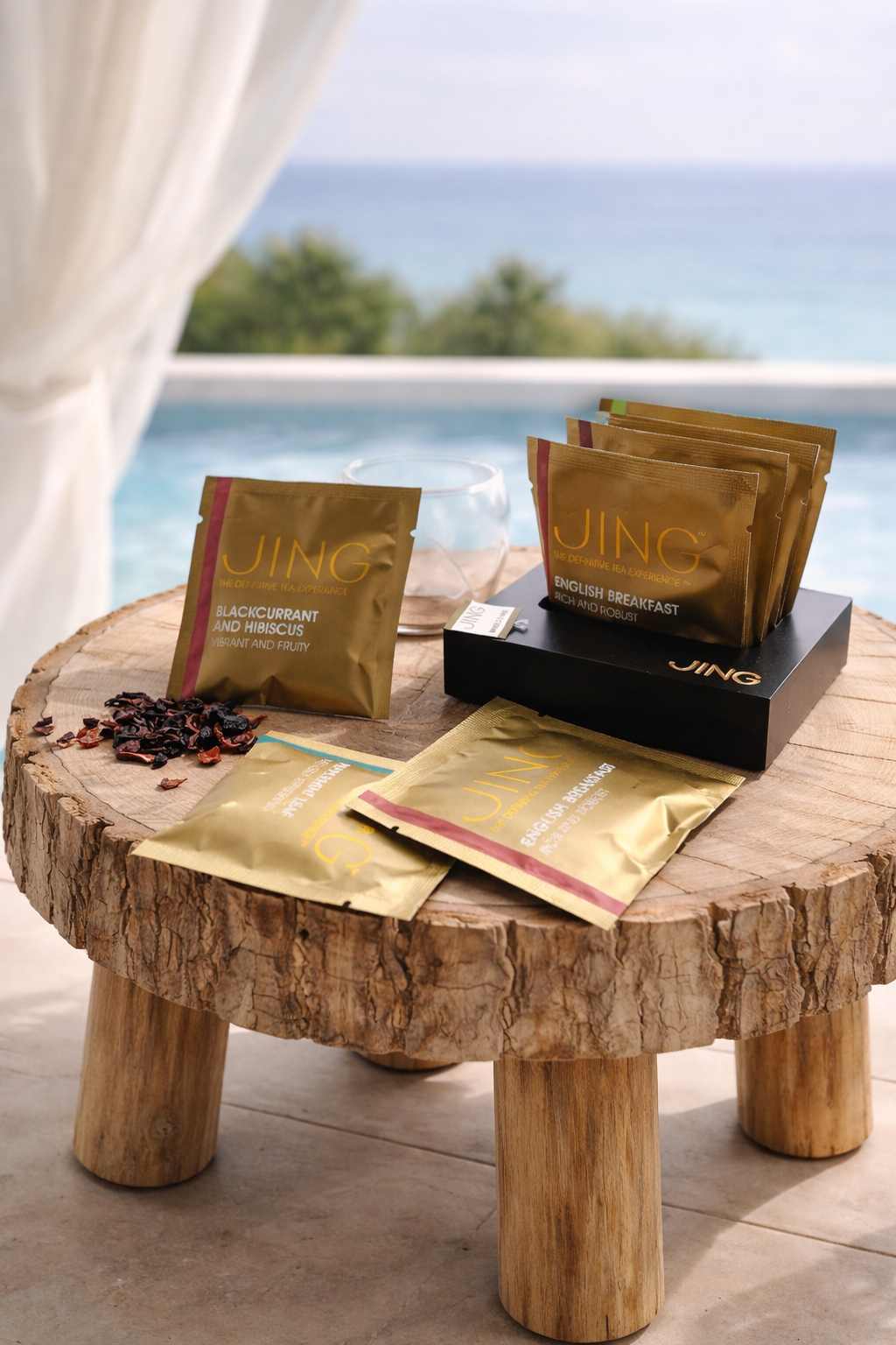 JING Tea collection on wooden table by the pool